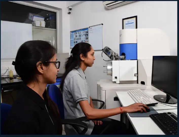Analysts at the SEM and EDS workstation in the Vadodara laboratory