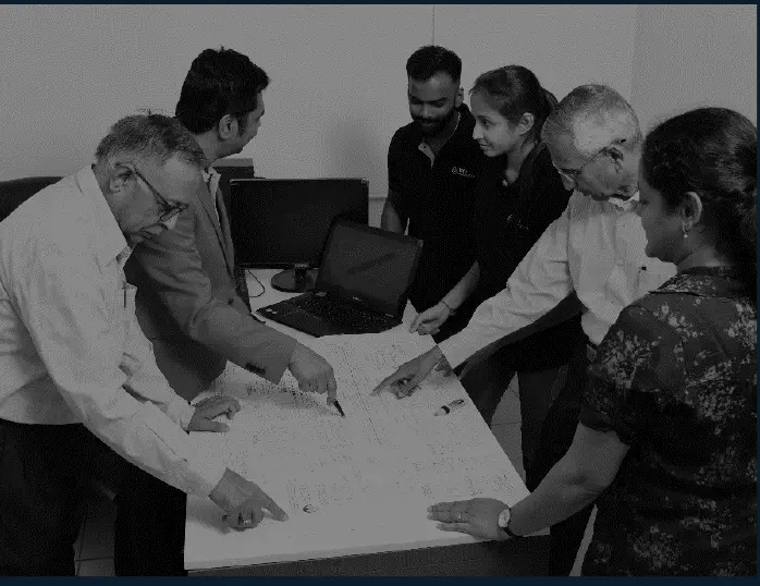 TCR Advanced engineers and plant engineers in a team study over drawings