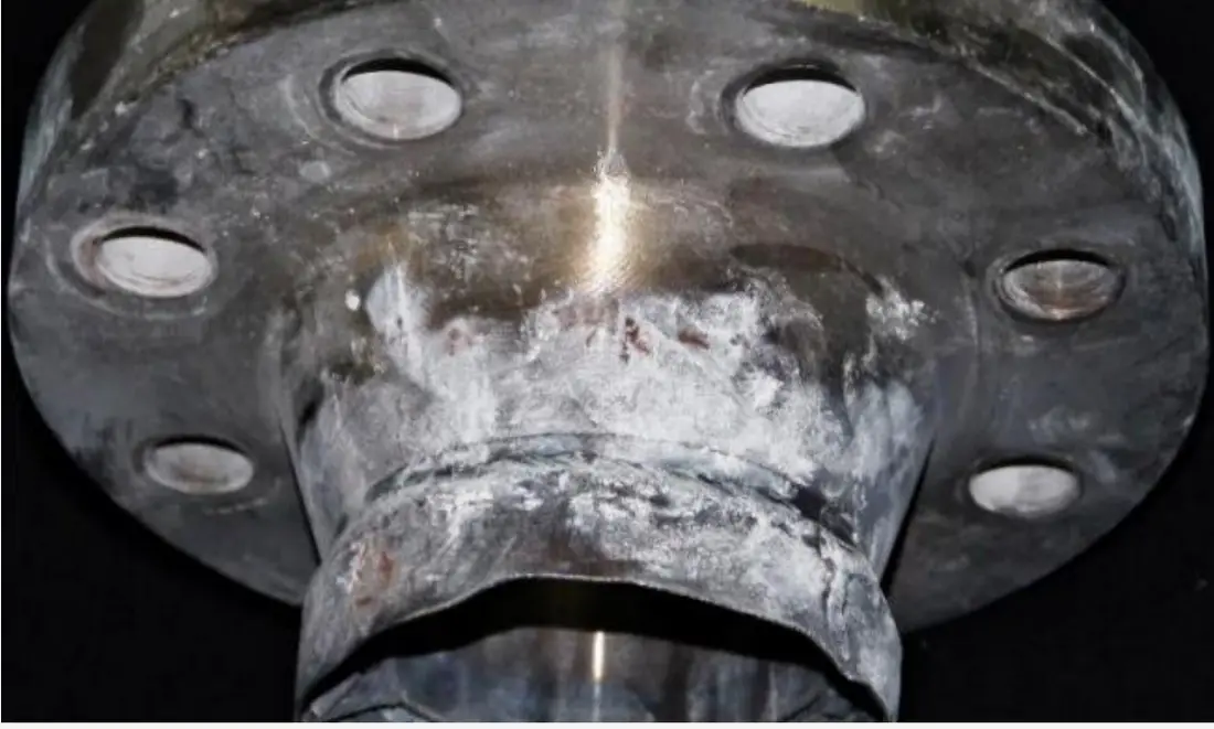 A burst small-bore flanged connection with the fracture face visible