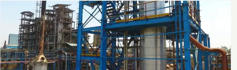 Blue-painted structural steel and process equipment on a plant being inspected during MIQA execution