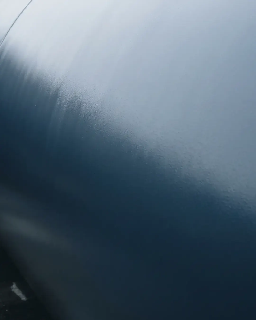 A freshly coated pipe surface with a cold even sheen