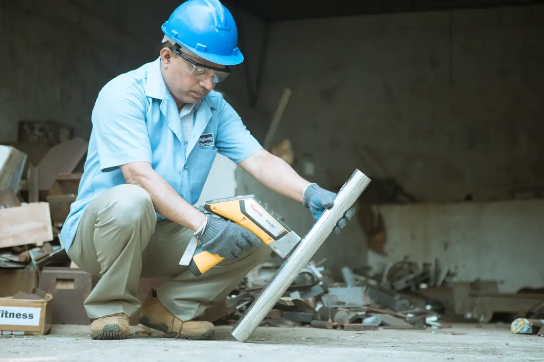 Positive material identification being carried out with a handheld analyser on installed pipework