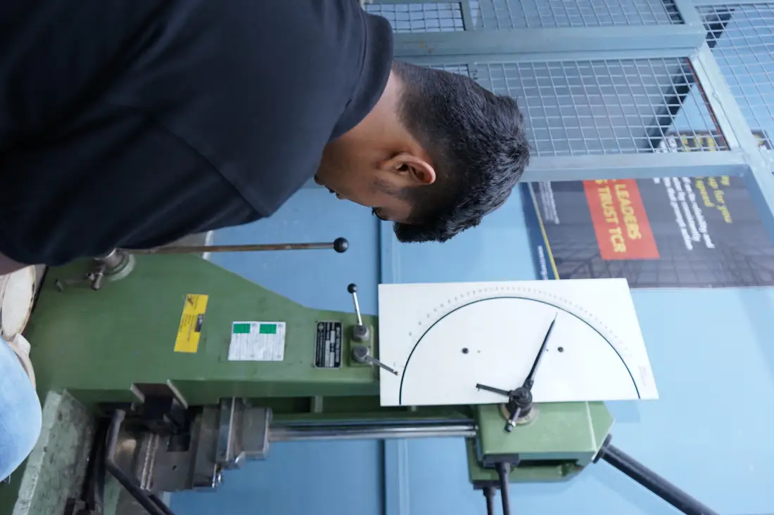 A Charpy pendulum impact tester at TCR Engineering with a notched specimen in the anvil