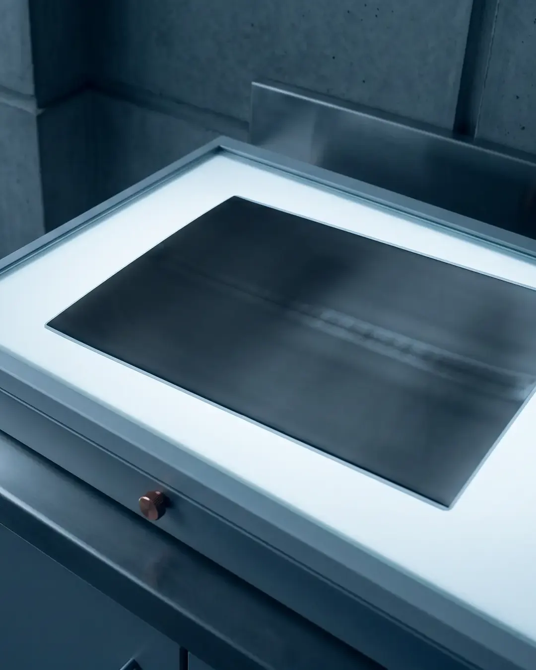 A radiographic film strip on a cold light box showing a weld density band