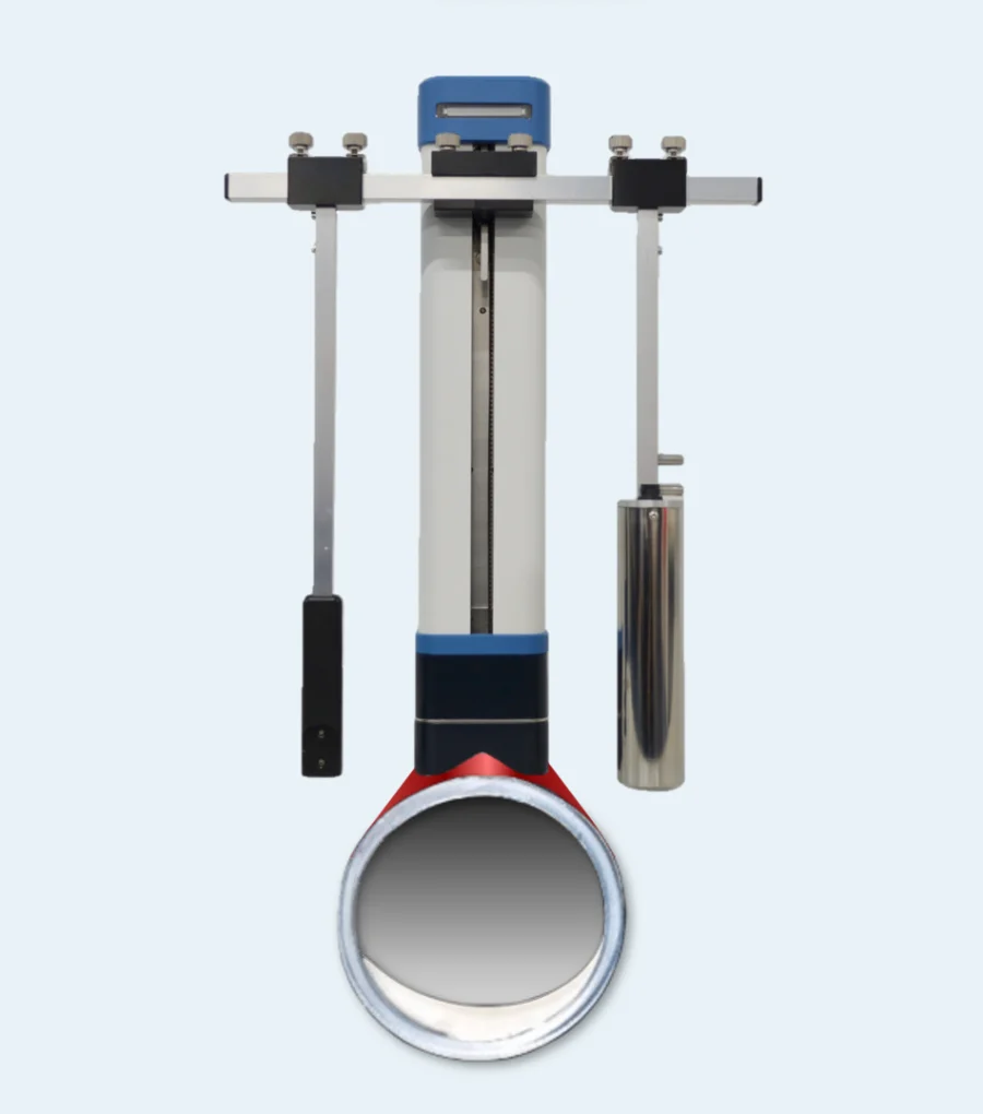 The Scale Checker instrument: a vertical scanning column with two horizontal arms carrying the source and the detector, clamped over a length of pipe