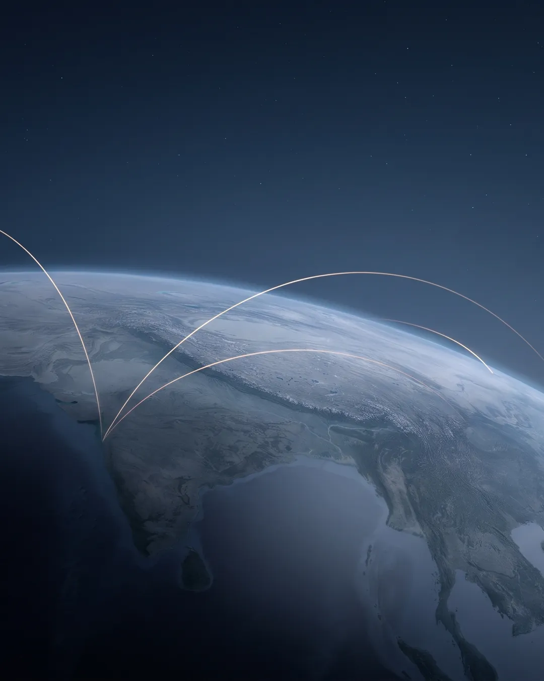The Indian subcontinent seen from orbit at blue hour, with slender light arcs curving out toward the Gulf, Southeast Asia and Japan