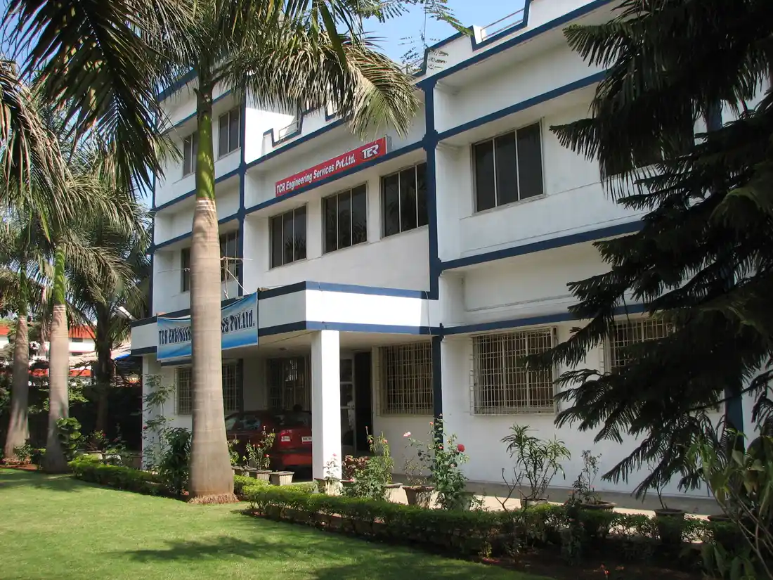 The TCR Engineering Services building, the company name and mark above the entrance, seen across the front lawn