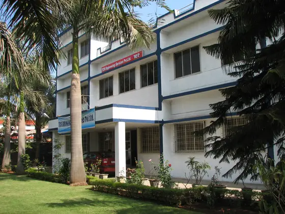The TCR Engineering Services building, the company name and mark above the entrance, seen across the front lawn