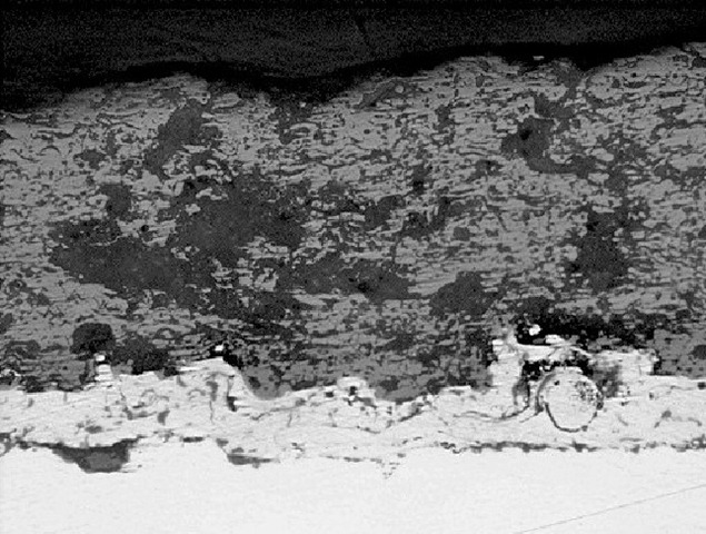 Optical micrograph of the same thermal spray coating system: coating-to-substrate interface bonding detail