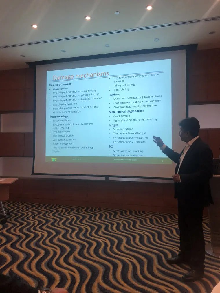 Paresh Haribhakti pointing to the damage mechanisms slide, which groups boiler damage into fluid-side corrosion, fireside wastage, rupture, metallurgical degradation, fatigue and stress corrosion cracking